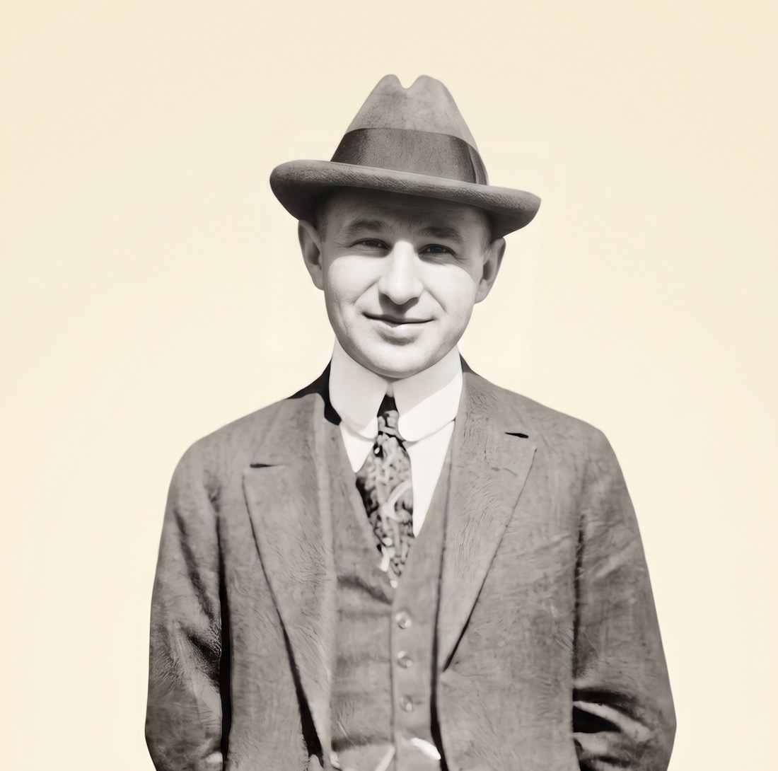 Portrait of John Danz (1877–1961), the Seattle film exhibitor who founded Sterling Theatres, in a hat and three-piece suit.